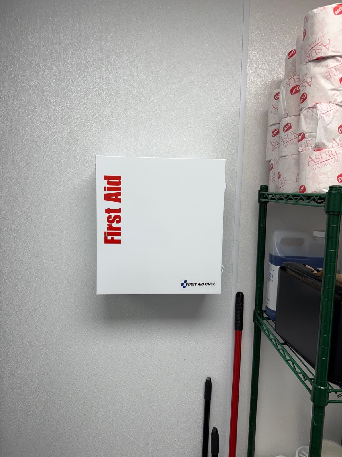 Wall-mounted First Aid Only cabinet installed at a DFW business